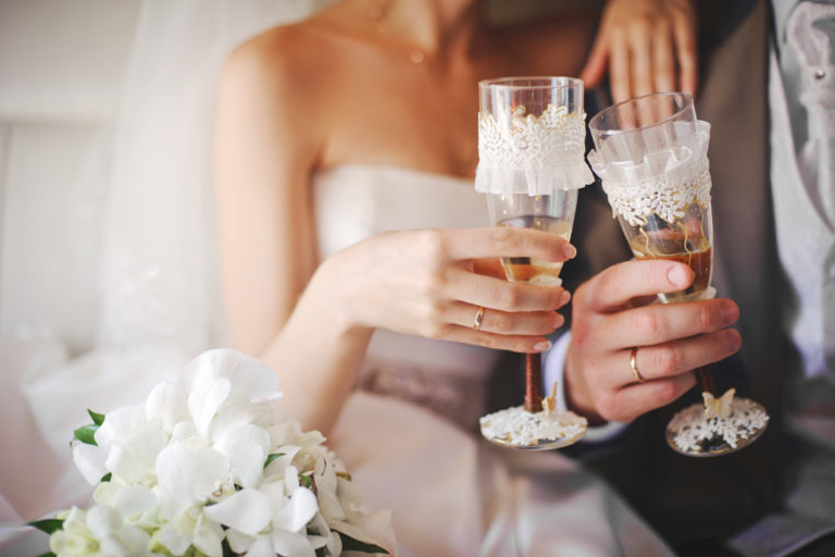 Bride and Groom Holding A Glass of Wine